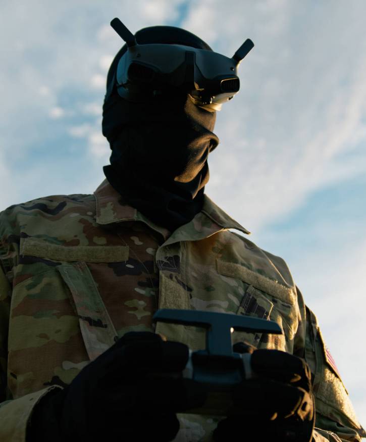 Man In Military Uniform With VR Headset Pilots A Drone Outdoors To Missiles Man In Military Uniform With VR Headset Pilots A Drone Outdoors To Missiles.